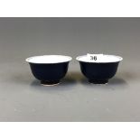 A pair of Chinese hand painted porcelain tea bowls with exterior deep blue glaze, D. 9.5cm