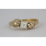 An 18ct yellow gold ring (stamped 18ct) set with a square emerald cut centre diamond, approx 0.