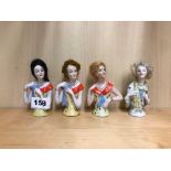 A group of four porcelain half doll figures with hair, H. 10cm.