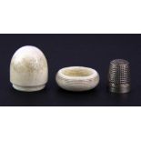 A 19th Century acorn shaped turned ivory thimble case containing a white metal thimble stamped