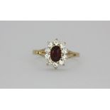 A 9ct yellow gold stone set cluster ring, (M.5).