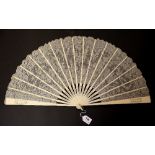 A Victorian carved ivory and lace fan in the original box, L. 36cm.