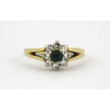 An 18ct yellow gold diamond and green stone set cluster ring, (I.5).