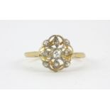 An Art Deco 18ct yellow gold (stamped 18ct) diamond set cluster ring, (N).