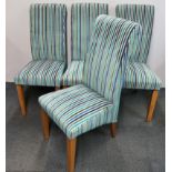 A set of four upholstered contemporary dining chairs.