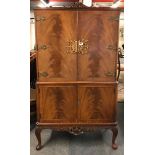 A mid 20th Century mahogany cocktail cabinet, W. 94cm, H. 153cm.