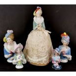 A group of five porcelain half dolls, one with pin cushion skirt, H. 21cm.