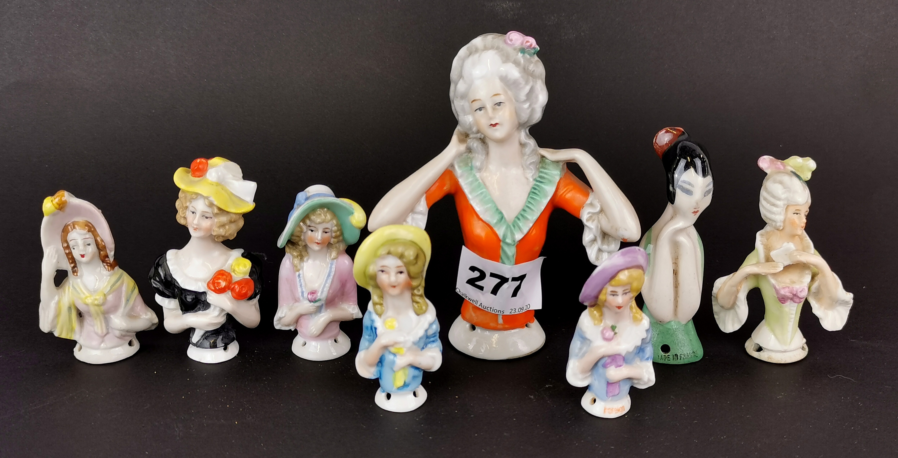 A group of eight porcelain half dolls, tallest 11.5cm.