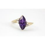 A 9ct yellow gold ring set with a large marquise cut amethyst and diamonds, (S).