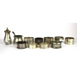 A quantity of hallmarked silver napkin rings and two cruet items.