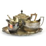 A three piece hallmarked silver tea set with hallmarked silver tray, Approx. 1.576g.