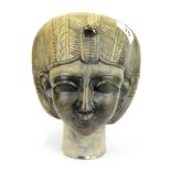An Egyptian carved stone mummy head signed to base H. 22cm.