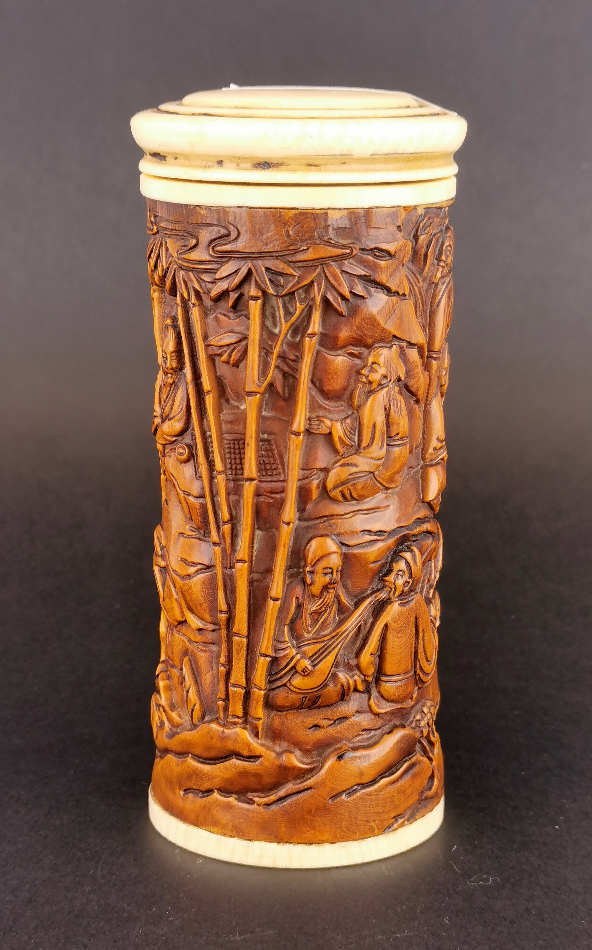 An early 20th century Chinese carved walnut wood box with ivory lid and base, H. 12cm.