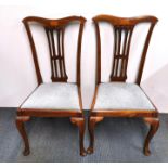 A pair of inlaid mahogany Chippendale style dining chairs.