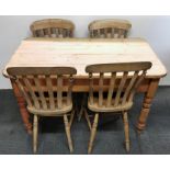 A 19th Century pine kitchen table, 70 x 122cm, together with four 19th Century kitchen chairs.
