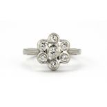 A 14ct white gold (stamped 14ct) diamond set flower shaped cluster ring, (N).