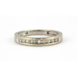 A 10ct white gold (stamped 10K) diamond set half eternity ring, (N).