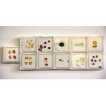 Eleven individually boxed unmounted semi precious gemstones.