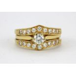 An 18ct yellow gold stone set engagement and wedding ring, (P).
