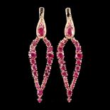 A pair of 925 silver rose gold gilt drop earrings set with round cut rubies, L. 5cm.