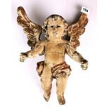 An 18th century carved and painted wooden cherub figure with glass eyes, H. 35cm, W. 28cm.