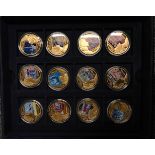 A box of sixteen commemorative enamelled coins with certificates.