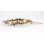 An Edwardian yellow metal (tested 9ct gold) bangle set with pink stone and pearls, L. 6.5cm, clasp