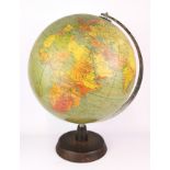 A vintage globe with turned wooden stand, H. 44cm.