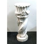A white porcelain planter on dolphin stand, H. 78cm.
