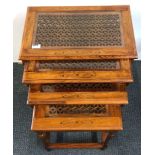 A nest of four brass inlaid teak side tables with glass tops, 54 x 33 x 54cm.
