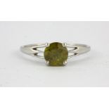 A 9ct white gold ring set with a round cut sphene, (S).