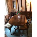 A mahogany extending pedestal dining table, extending from 153cm to 189cm, together with a set of