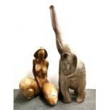 An unusual carved wooden female figure, H. 44cm, together with a carved hardwood elephant.