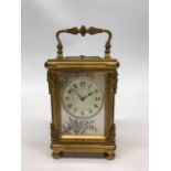 A fine early 20thC gilt brass French carriage clock with silvered mother of pearl dial and button
