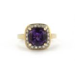 A 9ct yellow gold ring set with a cushion cut amethyst and diamonds, (K).