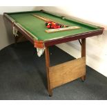 A folding snooker table, 94 x 186cm, with cues and balls.