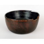 A 19th / early 20th century Tibetan turned wooden yak butter bowl with small cut away for