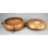 An Art Nouveau hammered copper fruit bowl, D. 23cm, and copper bed warmer.