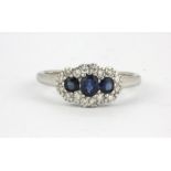An 18ct white gold sapphire and diamond set cluster ring, (L).