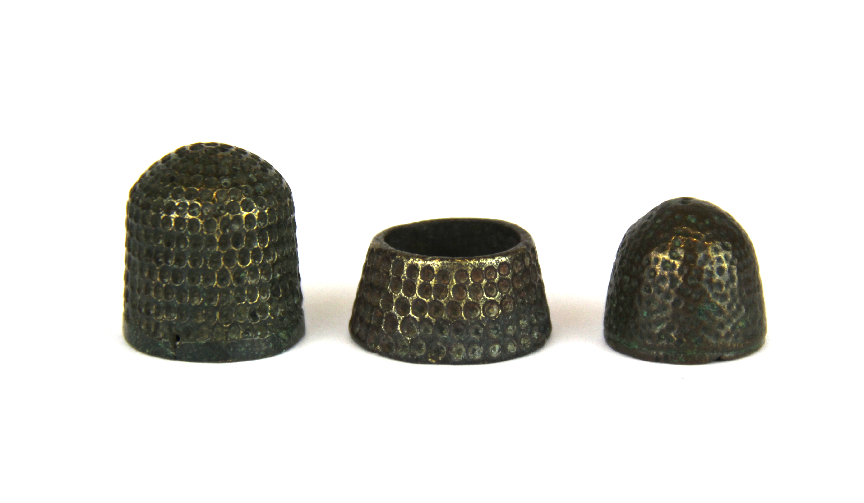 A 14th Century Medieval bronze beehive thimble, together with a similar period bronze tailor's