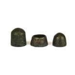A 14th Century Medieval bronze beehive thimble, together with a similar period bronze tailor's