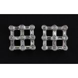 A pair of 18ct white gold (stamped 18K) diamond set stud earrings set with round and baguette cut