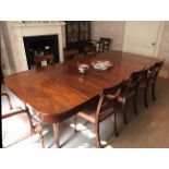 A superb Georgian mahogany extending dining table with reeded legs and lions paw feet, extending