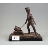 A 19th Century cast bronze match striker on a black slate base, H. 18cm.