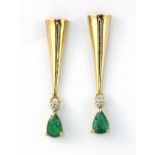 A pair of 10ct yellow gold (stamped 10k) drop earrings set with pear cut emeralds and diamonds, L.