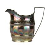 A Georgian hallmarked silver milk jug, H. 10.5cm.