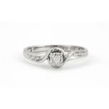 A 9ct white gold diamond set solitaire ring with diamond set shoulders, ().