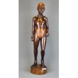 A large African carved hardwood figure of a man, H. 64cm, (A/F to left ankle).