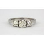 An 18ct white gold (stamped 750) ring set with three brilliant cut diamonds, approx 1ct, (M).