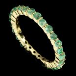 A 925 silver gilt full eternity ring set with emeralds, (P.5).